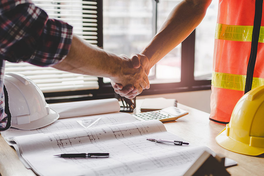 how-to-prepare-for-your-design-center-meeting construction worker team hands shaking after consultation meeting to greeting start up plan new project contract in office center at construction site, teamwork, partnership and contractor concept